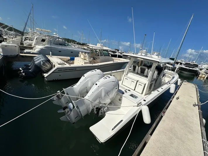  Yacht Photos Pics 2023 Pursuit S 358 Sport boat docked in a marina with twin outboard engines.
