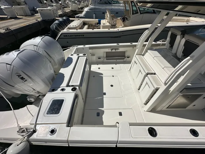  Yacht Photos Pics 2023 Pursuit S 358 Sport boat with dual Yamaha engines, spacious deck, and seating area.