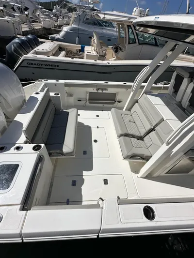  Yacht Photos Pics 2023 Pursuit S 358 Sport boat with spacious deck and seating area.