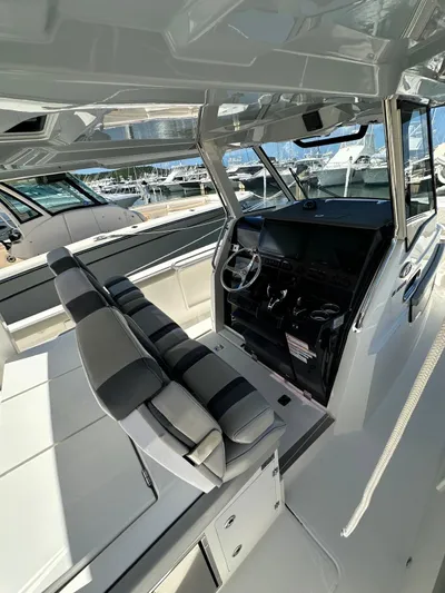  Yacht Photos Pics 2023 Pursuit S 358 Sport boat interior with modern helm and seating.