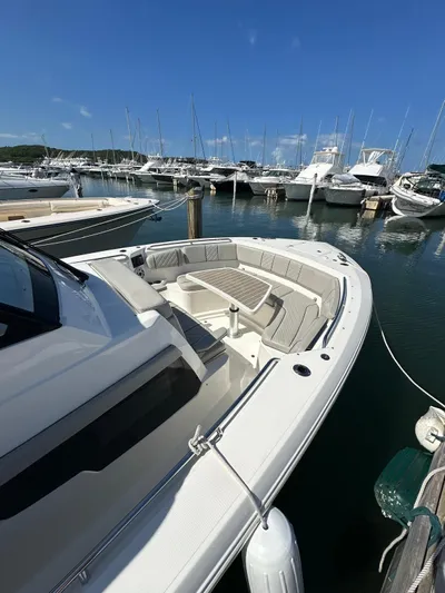  Yacht Photos Pics 2023 Pursuit S 358 Sport boat docked in marina under clear blue sky.