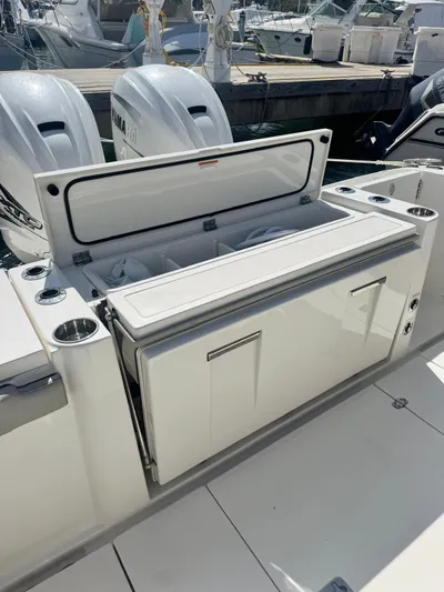  Yacht Photos Pics 2023 Pursuit S 358 Sport boat with open storage compartment and twin engines.