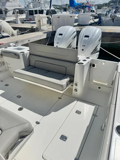 Yacht Photos Pics 2023 Pursuit S 358 Sport boat with dual engines and spacious seating at a marina.