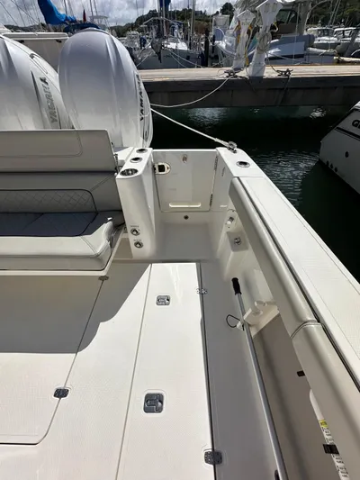  Yacht Photos Pics 2023 Pursuit S 358 Sport boat deck with seating and docked in marina.
