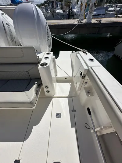  Yacht Photos Pics 2023 Pursuit S 358 Sport boat interior with seating and dock view.