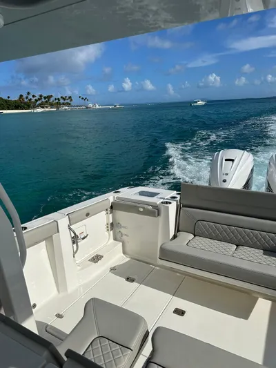  Yacht Photos Pics 2023 Pursuit S 358 Sport boat cruising on tropical waters.