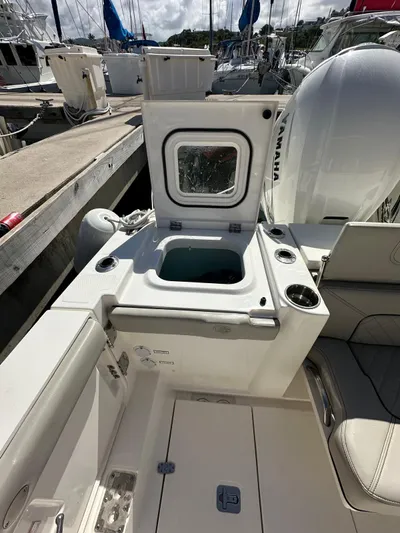  Yacht Photos Pics 2023 Pursuit S 358 Sport boat interior with open storage compartment.