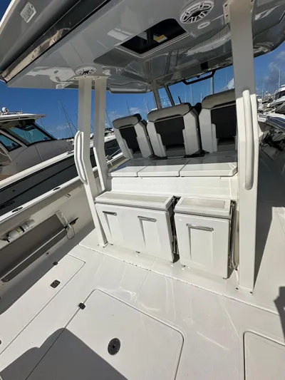  Yacht Photos Pics 2023 Pursuit S 358 Sport boat interior with seating and storage.