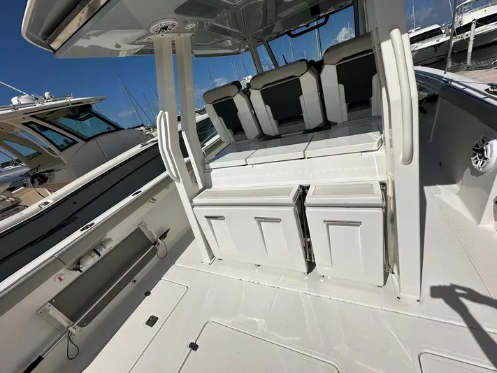  Yacht Photos Pics 2023 Pursuit S 358 Sport boat interior with seating and storage compartments.