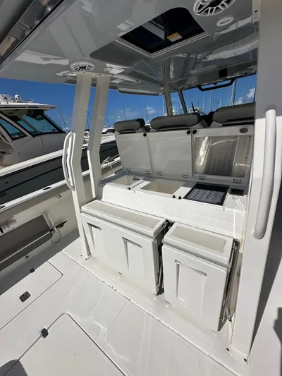  Yacht Photos Pics 2023 Pursuit S 358 Sport boat interior with seating and storage compartments.