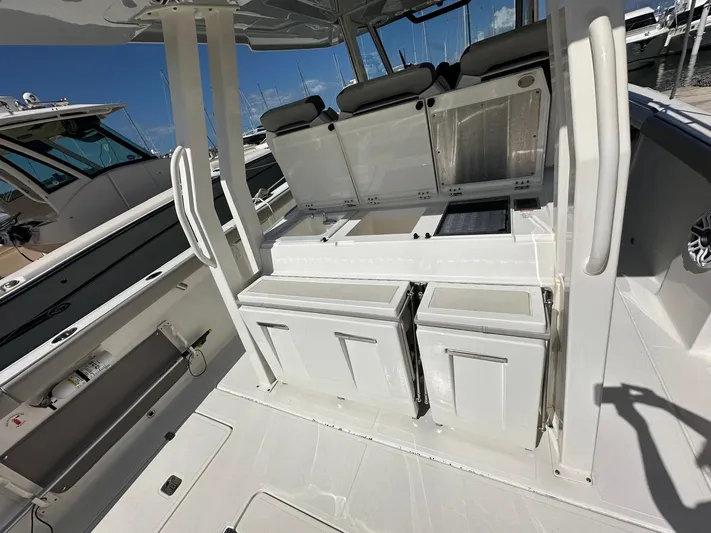  Yacht Photos Pics 2023 Pursuit S 358 Sport boat interior with seating and storage compartments.