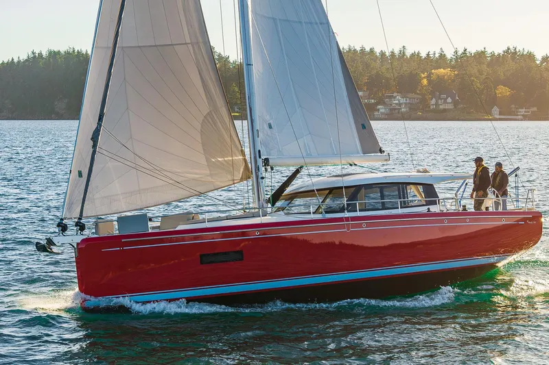 In Stock - W / Warranty Yacht Photos Pics 2024 Moody 41ds sailboat with red hull sailing on a sunny day.