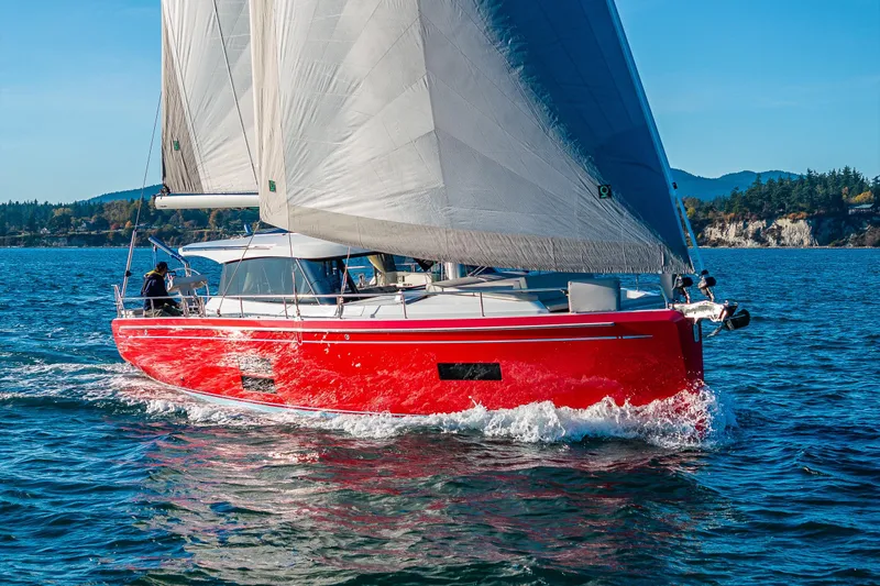 In Stock - W / Warranty Yacht Photos Pics Red 2024 Moody 41ds sailboat navigating clear blue waters.