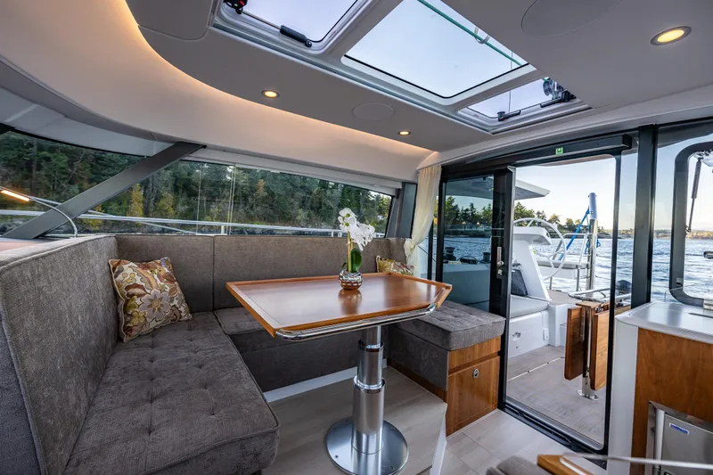 In Stock - W / Warranty Yacht Photos Pics Luxurious interior of 2024 Moody 41DS yacht with elegant seating and panoramic windows.