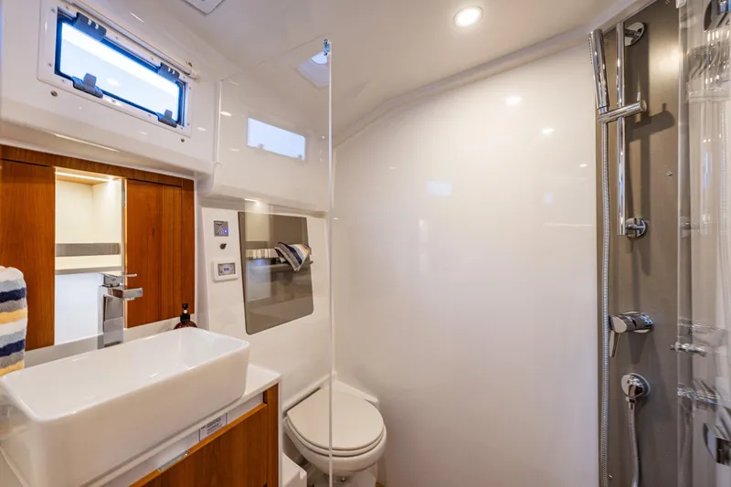 In Stock - W / Warranty Yacht Photos Pics Luxurious bathroom in 2024 Moody 41ds yacht, featuring modern fixtures and elegant design.