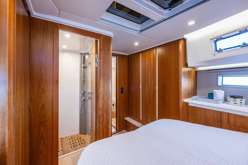 In Stock - W / Warranty Yacht Photos Pics Luxurious 2024 Moody 41ds yacht interior with wood paneling and modern bathroom.