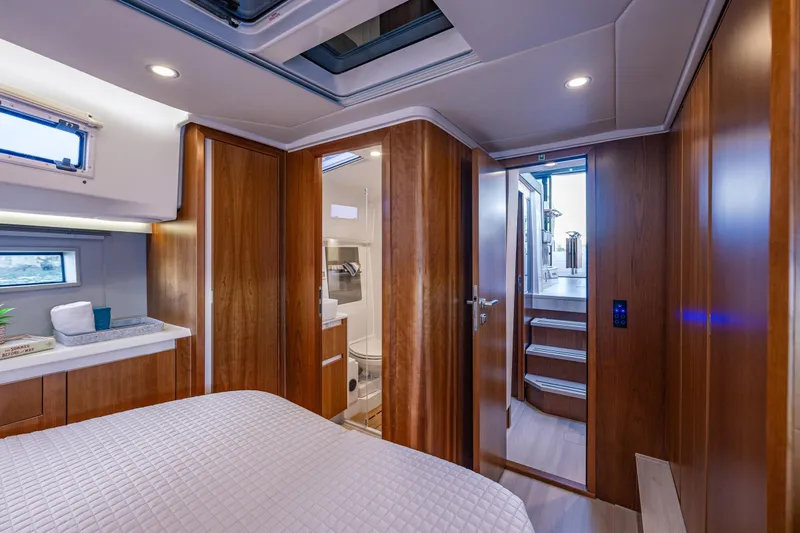 In Stock - W / Warranty Yacht Photos Pics Luxurious 2024 Moody 41ds yacht interior with wood paneling and modern amenities.