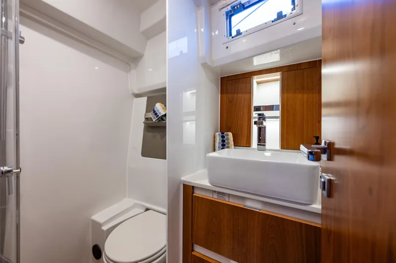 In Stock - W / Warranty Yacht Photos Pics Modern bathroom in 2024 Moody 41ds yacht with sleek fixtures and wooden cabinetry.