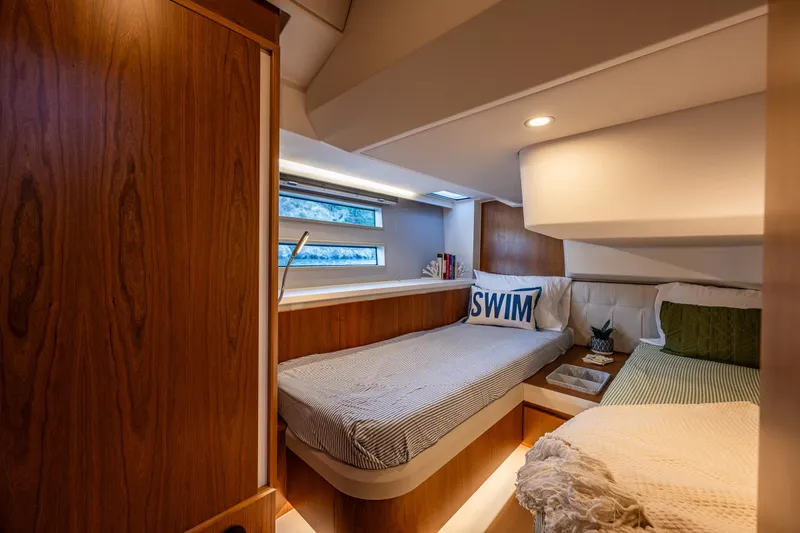In Stock - W / Warranty Yacht Photos Pics Luxurious 2024 Moody 41ds yacht cabin with cozy twin beds and elegant wood finish.