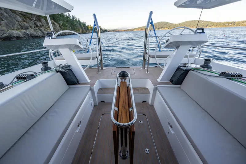 In Stock - W / Warranty Yacht Photos Pics 2024 Moody 41ds yacht cockpit with dual steering wheels, scenic water view.