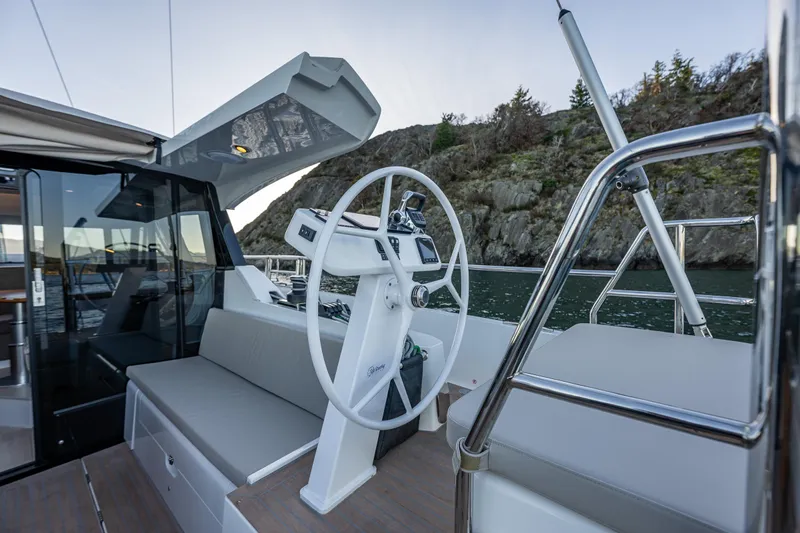 In Stock - W / Warranty Yacht Photos Pics 2024 Moody 41ds yacht helm with modern design, featuring a sleek steering wheel and comfortable seating.