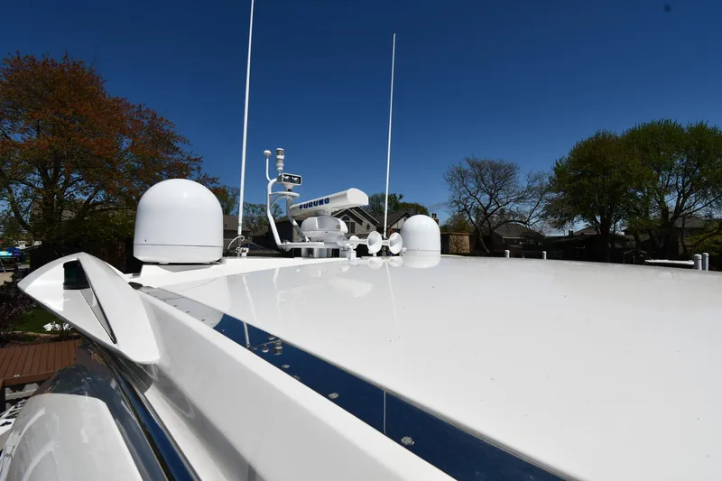 Loudmouth Soup Yacht Photos Pics Sunseeker 68 Predator 2002 yacht roof with antennas and clear blue sky.