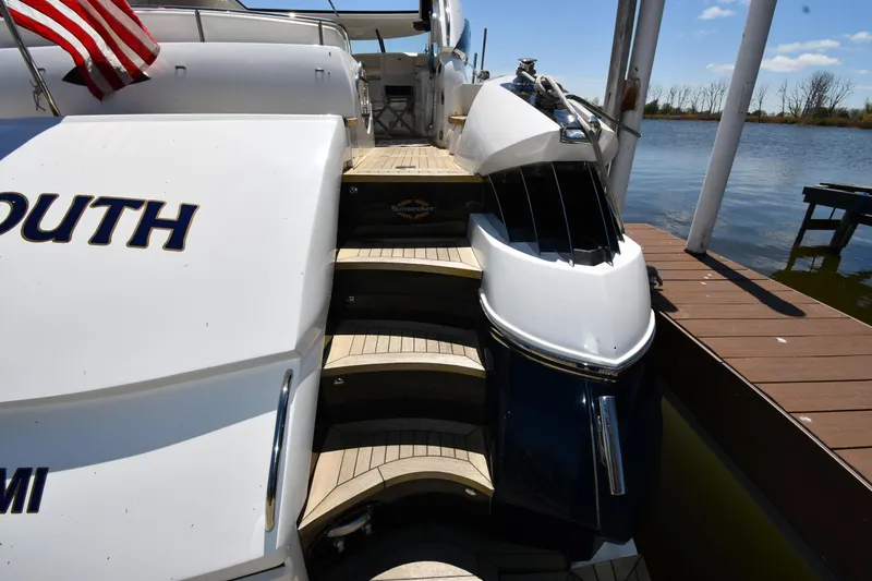 Loudmouth Soup Yacht Photos Pics 2002 Sunseeker 68 Predator yacht docked, featuring elegant wooden steps and sleek design.