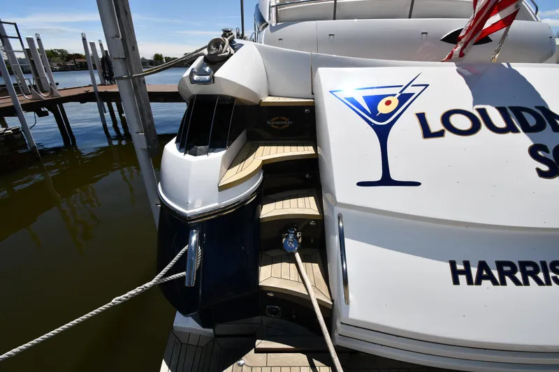 Loudmouth Soup Yacht Photos Pics Sunseeker 68 Predator yacht docked, featuring sleek design and custom graphics, 2002 model.