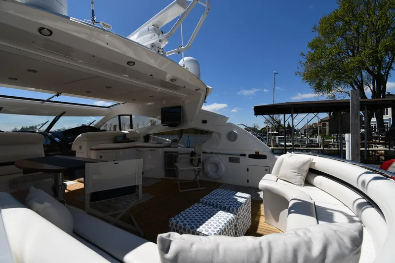 Loudmouth Soup Yacht Photos Pics Luxurious 2002 Sunseeker 68 Predator yacht with spacious outdoor seating and modern amenities.