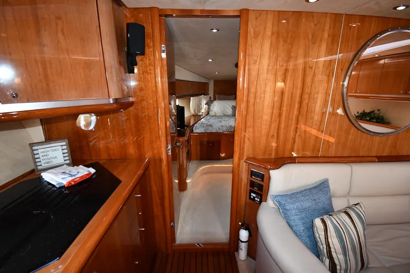 Loudmouth Soup Yacht Photos Pics Luxurious interior of 2002 Sunseeker 68 Predator yacht with wood finish and cozy seating.