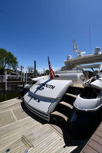 Loudmouth Soup Yacht Photos Pics Sunseeker 68 Predator 2002 yacht docked, featuring sleek design and American flag.