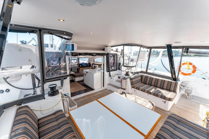 Wikiwiki Yacht Photos Pics Spacious interior of 2018 Outremer 5X catamaran with striped seating and large windows.