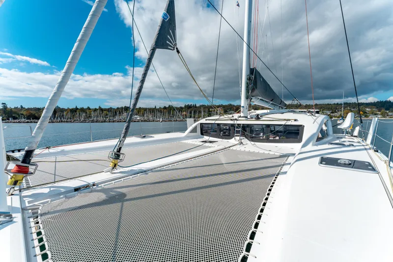Wikiwiki Yacht Photos Pics 2018 Outremer 5X catamaran on water, showcasing deck and sails under blue sky.