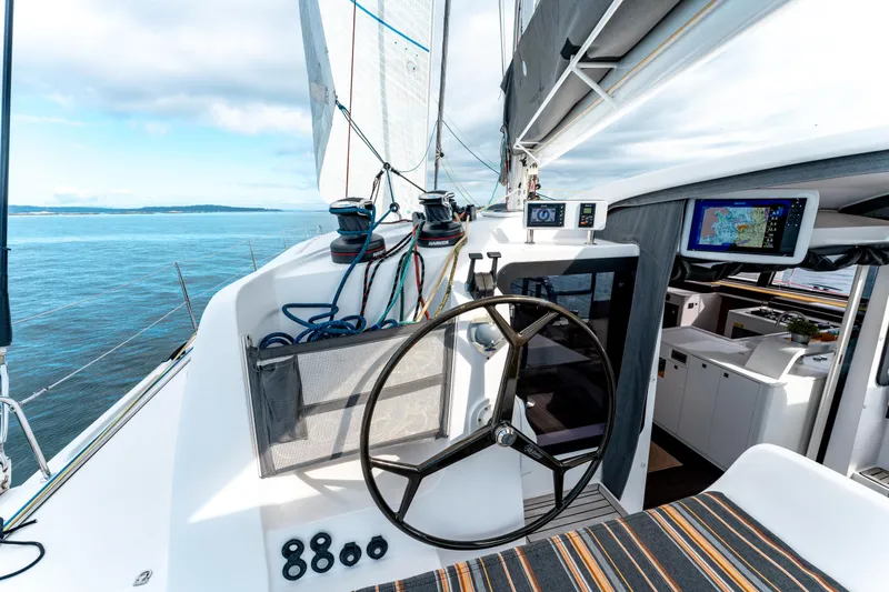 Wikiwiki Yacht Photos Pics 2018 Outremer 5X yacht cockpit with steering wheel, navigation equipment, and ocean view.