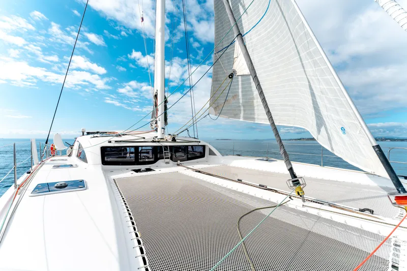 Wikiwiki Yacht Photos Pics 2018 Outremer 5X catamaran sailing on open sea under clear blue skies.