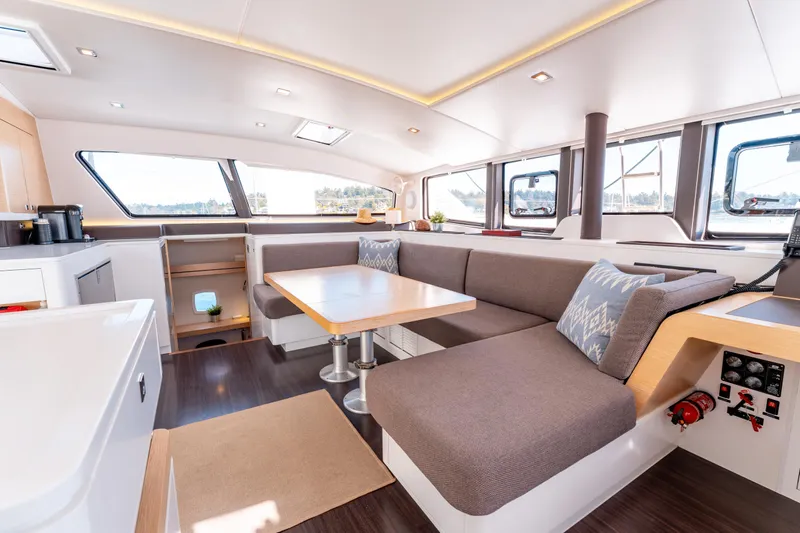 Wikiwiki Yacht Photos Pics Spacious interior of 2018 Outremer 5X catamaran with modern seating and dining area.
