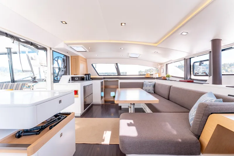 Wikiwiki Yacht Photos Pics Spacious interior of 2018 Outremer 5X catamaran with modern seating and dining area.