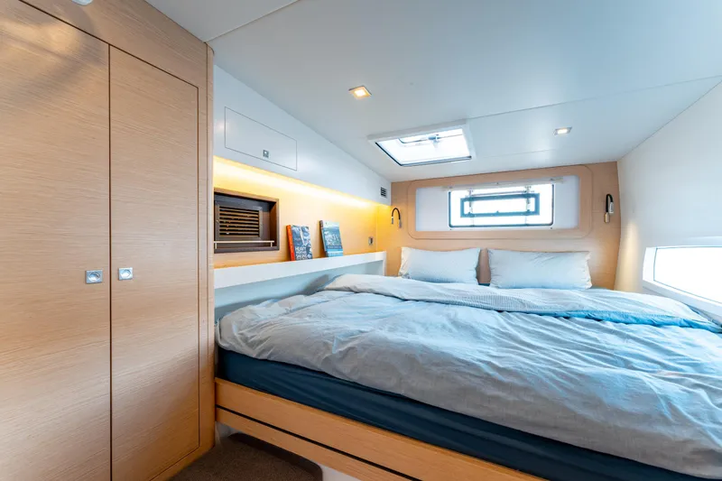 Wikiwiki Yacht Photos Pics Luxurious cabin interior of 2018 Outremer 5X yacht with cozy bed and modern design.