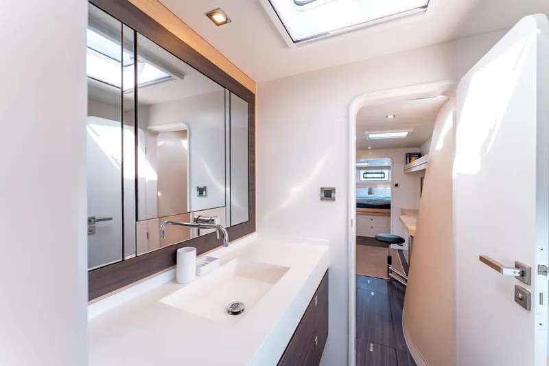 Wikiwiki Yacht Photos Pics Luxurious bathroom interior of 2018 Outremer 5X yacht with modern fixtures and ample lighting.