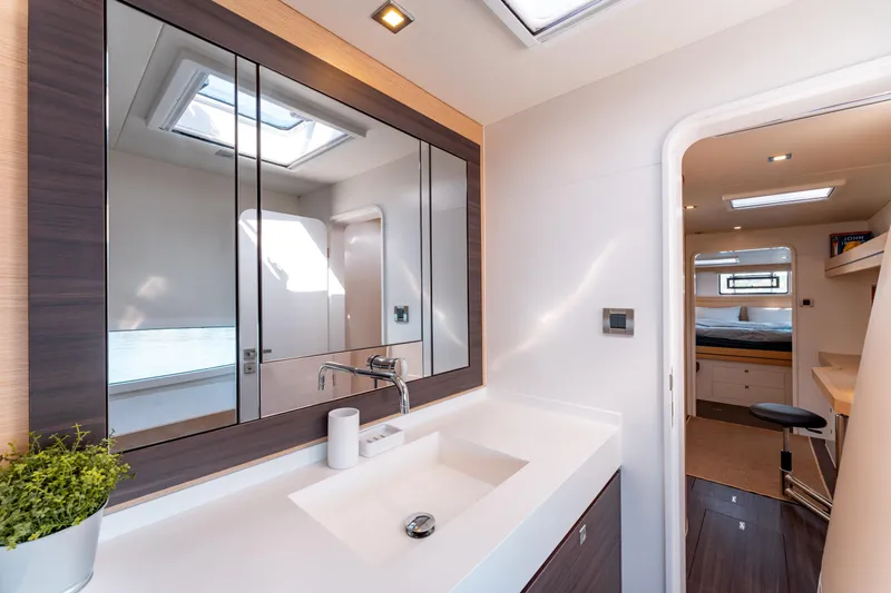Wikiwiki Yacht Photos Pics Luxurious bathroom interior of 2018 Outremer 5X yacht with modern fixtures and skylight.