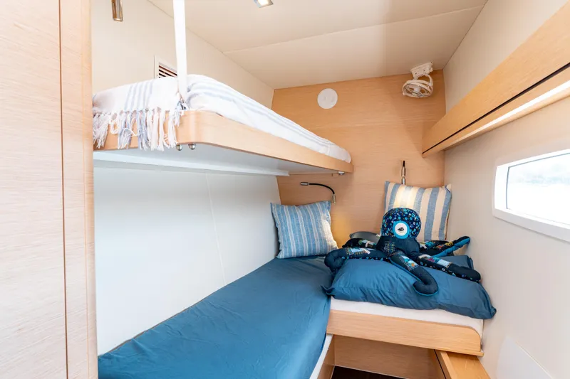Wikiwiki Yacht Photos Pics Cozy cabin with bunk beds in 2018 Outremer 5X catamaran, featuring nautical decor.