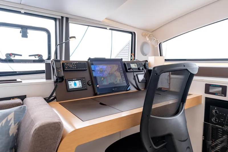 Wikiwiki Yacht Photos Pics Navigation station of 2018 Outremer 5X catamaran with modern equipment and comfortable seating.
