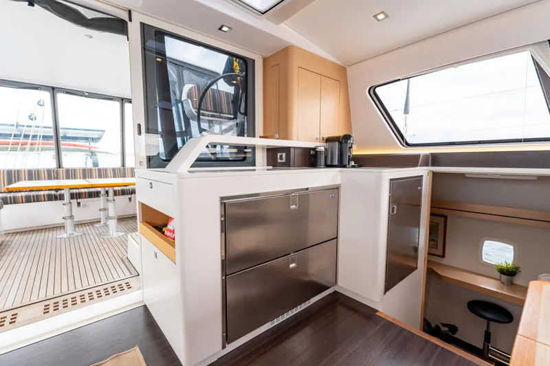 Wikiwiki Yacht Photos Pics Interior of 2018 Outremer 5X catamaran, featuring modern kitchen and seating area.