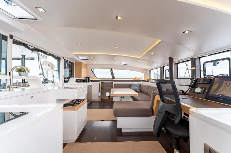 Wikiwiki Yacht Photos Pics Luxurious interior of 2018 Outremer 5X catamaran with modern furnishings and navigation equipment.