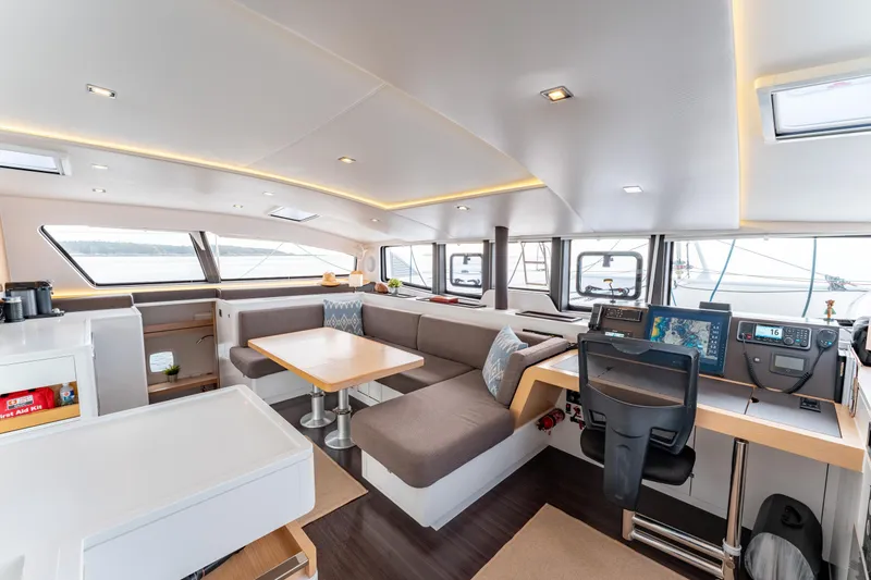 Wikiwiki Yacht Photos Pics Luxurious interior of 2018 Outremer 5X catamaran with modern seating and navigation area.