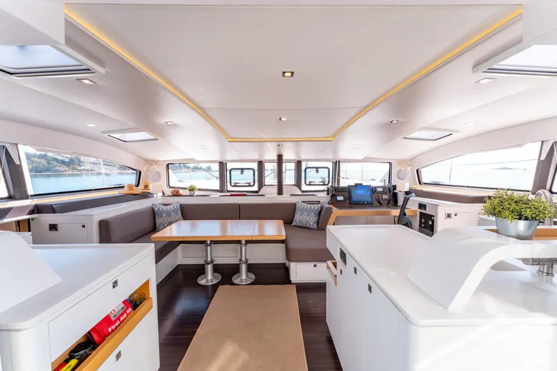 Wikiwiki Yacht Photos Pics Luxurious interior of 2018 Outremer 5X catamaran with modern seating and navigation area.