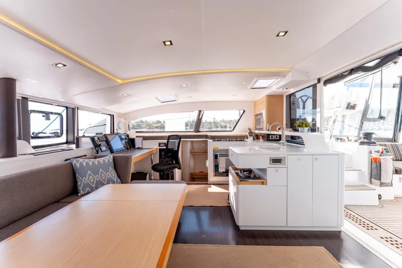 Wikiwiki Yacht Photos Pics Luxurious interior of 2018 Outremer 5X catamaran with modern kitchen and seating area.