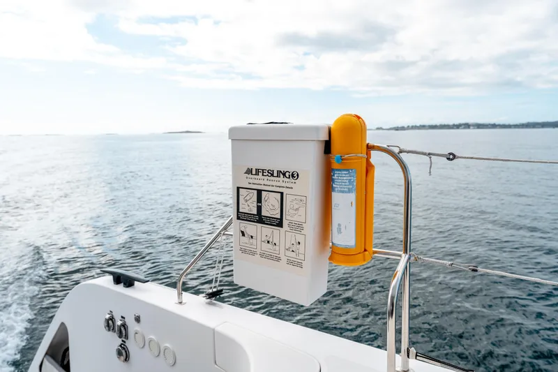 Wikiwiki Yacht Photos Pics Outremer 5X 2018 yacht with lifesaving equipment on deck, sailing on calm waters.