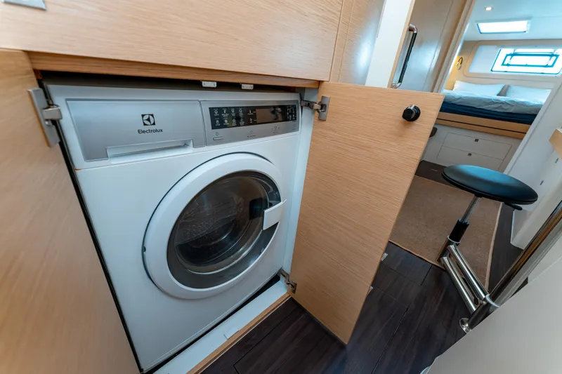 Wikiwiki Yacht Photos Pics Laundry area with washing machine in 2018 Outremer 5X yacht interior.