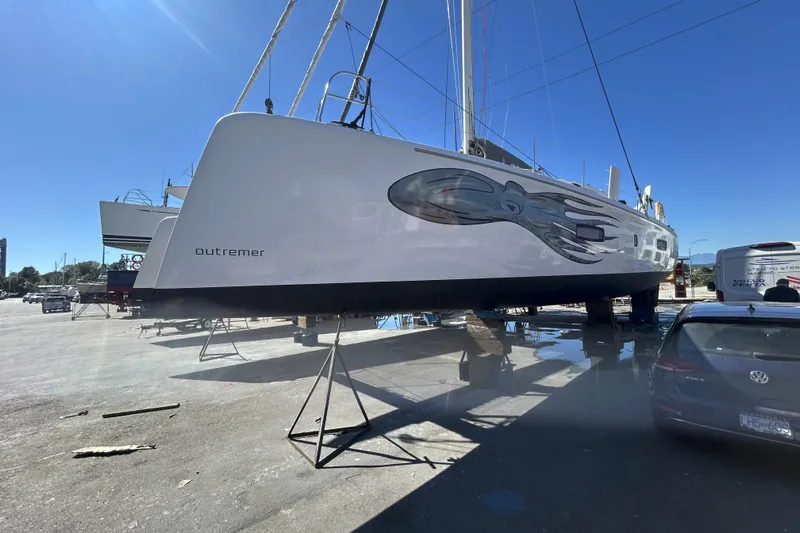 Wikiwiki Yacht Photos Pics 2018 Outremer 5X catamaran on dry dock under clear blue sky.